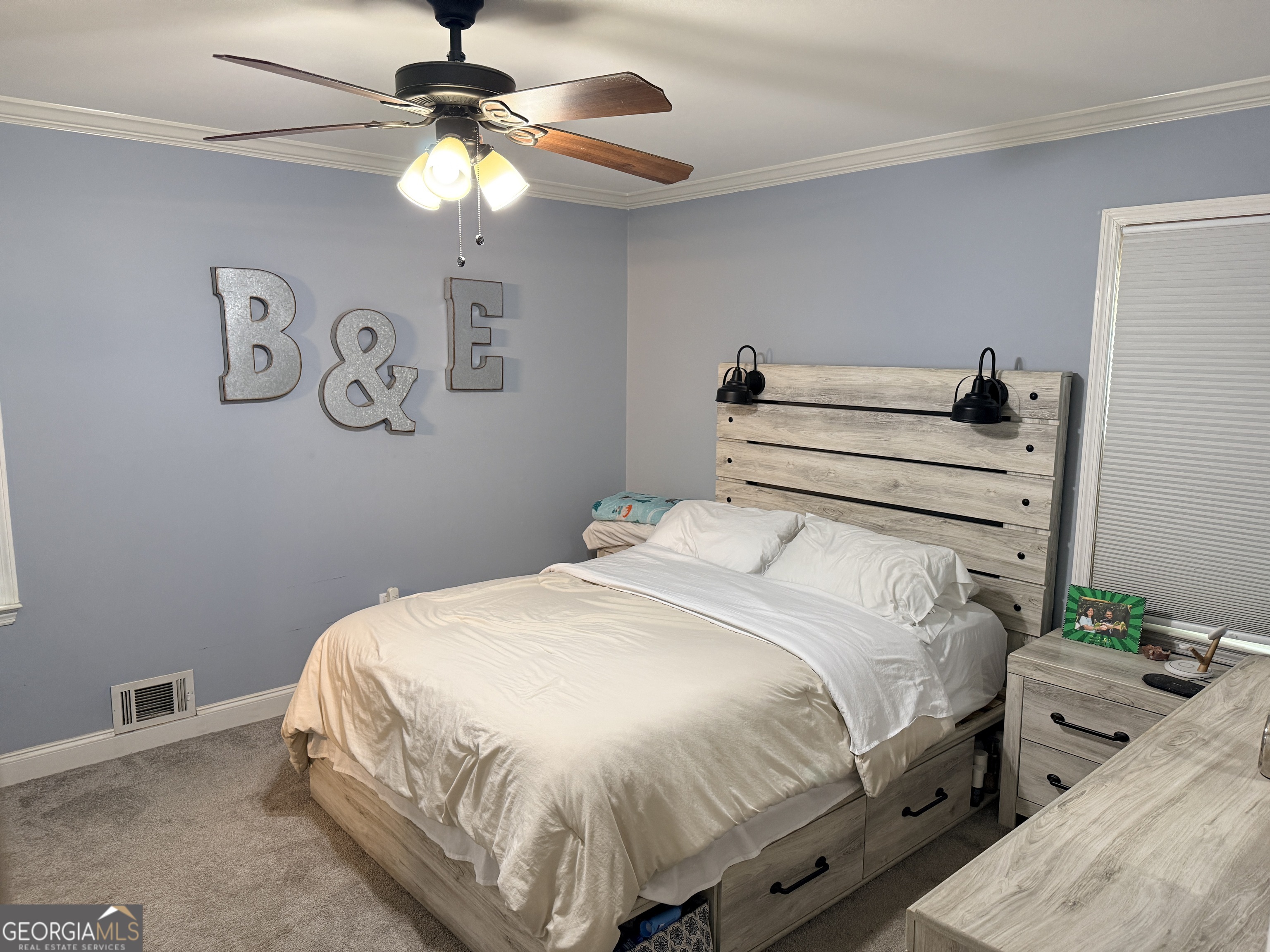 171 Candy Circle Winterville, GA 30683 - Photo 11 of 16 a bedroom with a bed and a chandelier