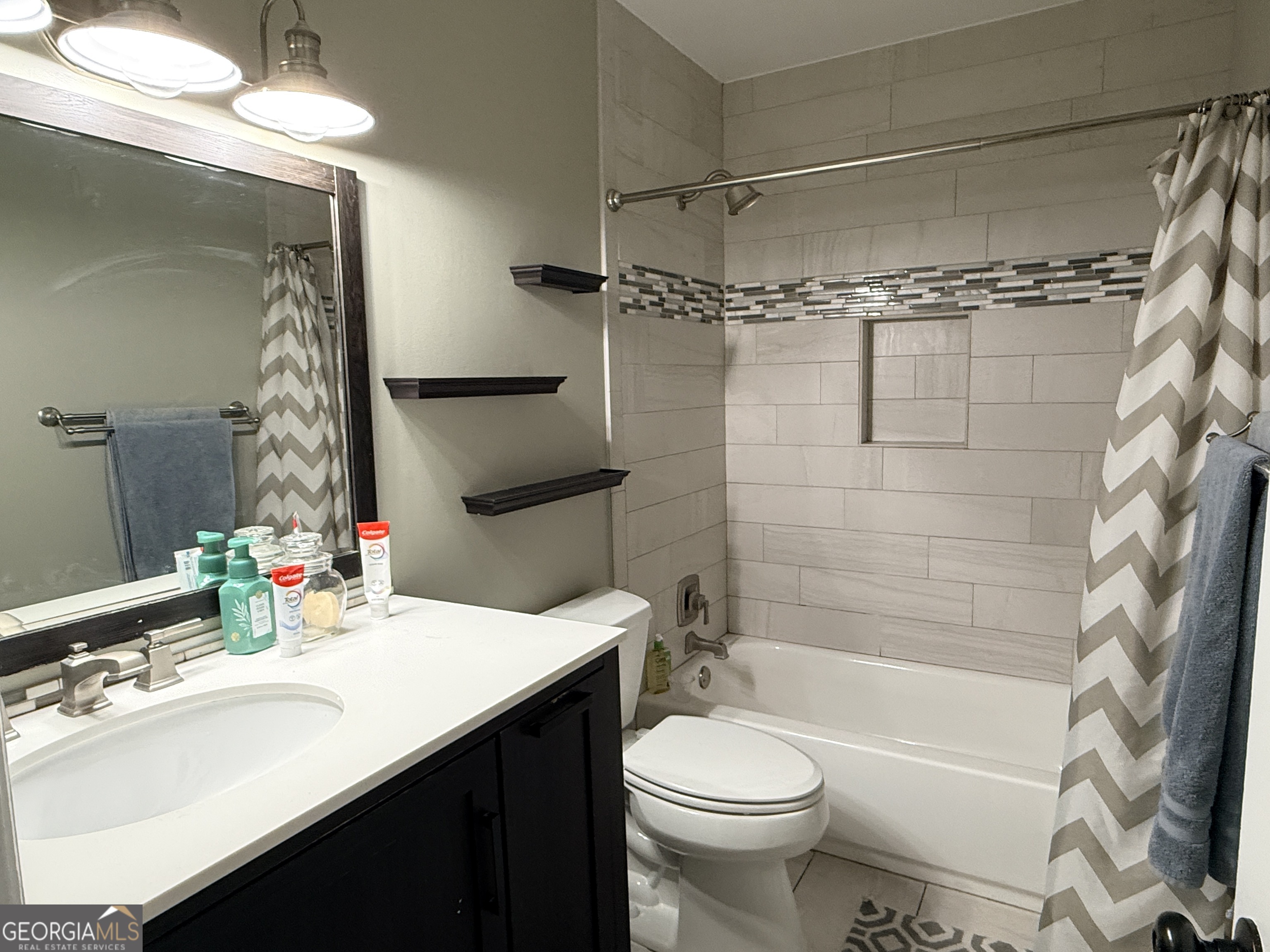 171 Candy Circle Winterville, GA 30683 - Photo 12 of 16 a bathroom with a sink a toilet and shower