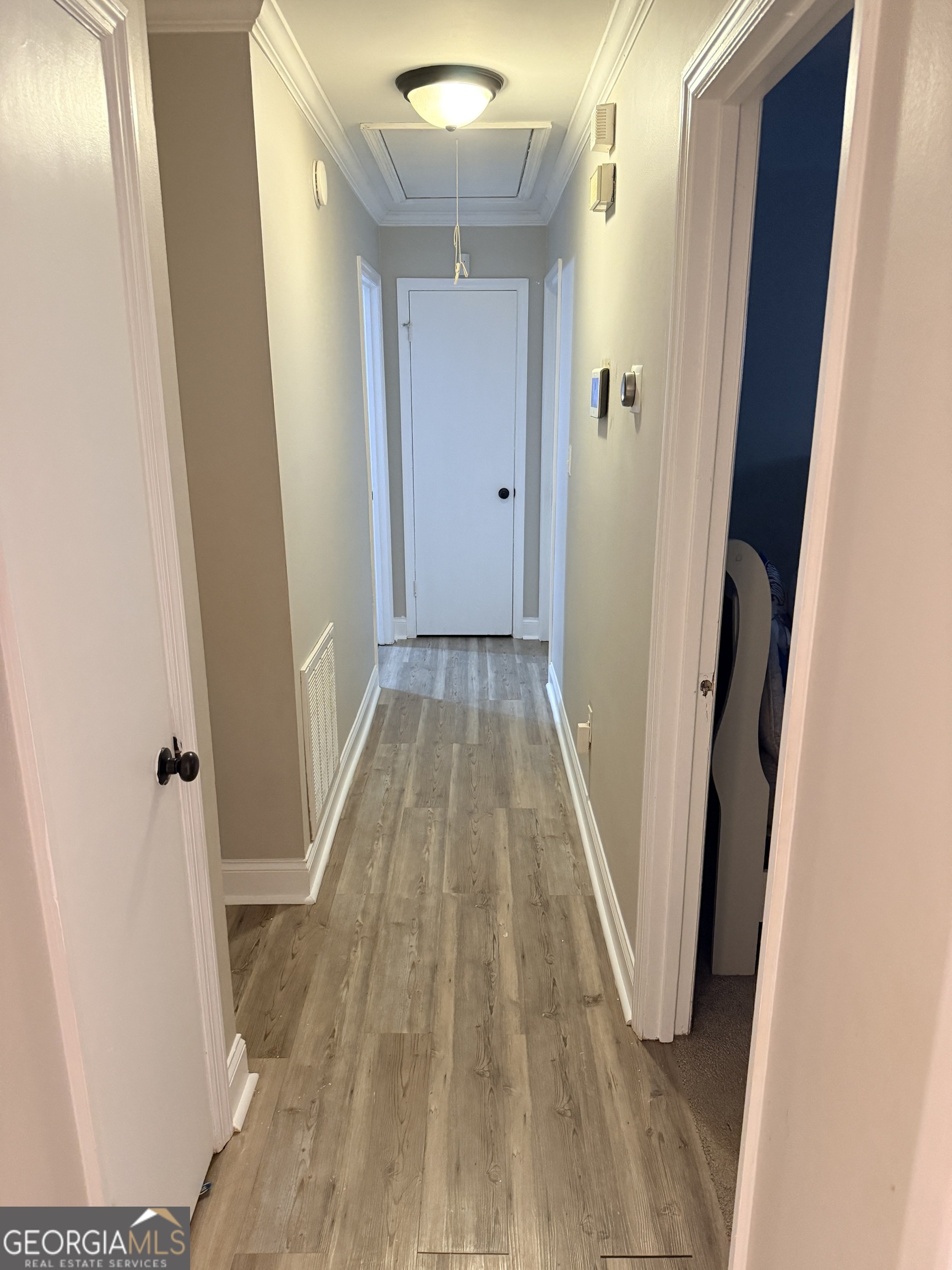 171 Candy Circle Winterville, GA 30683 - Photo 7 of 16 a view of a hallway with wooden floor and staircase