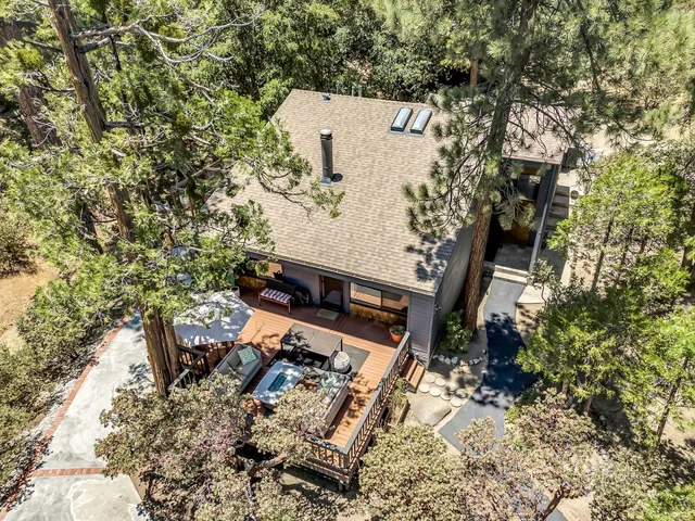 a front view of a house with balcony and trees