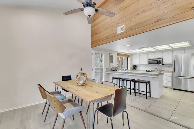 a room with pool table and windows