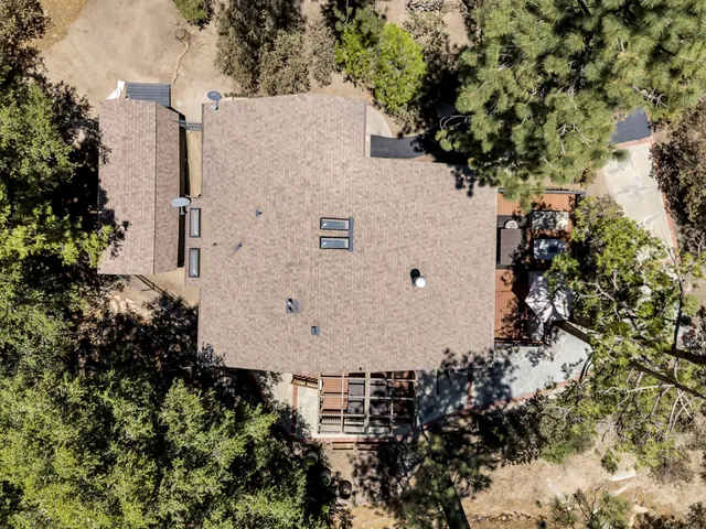 a view of backyard with outdoor seating and trees