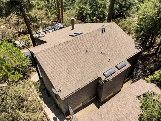 a view of a livingroom with furniture wooden floor window and fireplace