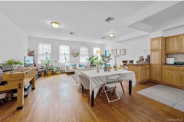 a view of a dining room kitchen with furniture and wooden floor