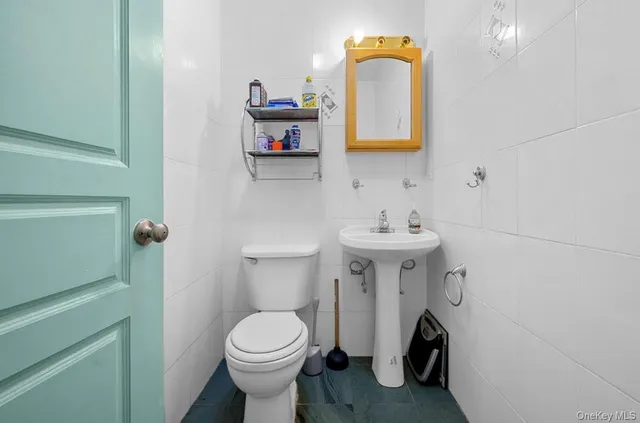 a bathroom with a sink toilet and mirror