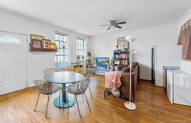 a dining room with furniture and wooden floor