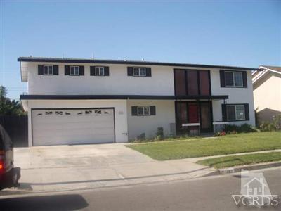 a view of a house with a yard and a garage