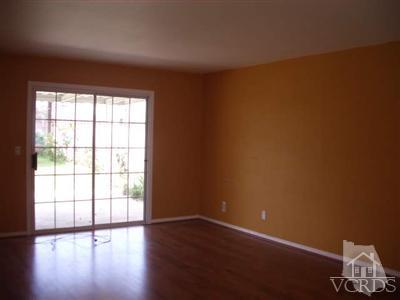 Undisclosed Address Simi Valley, CA 93065 - Photo 3 of 5 a view of an empty room with wooden floor and a window