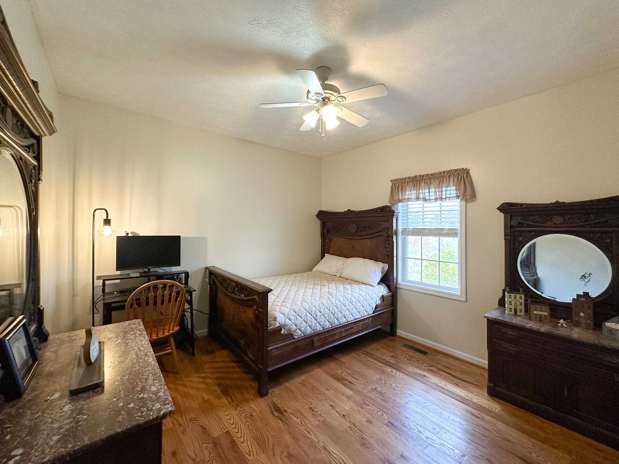 3427 Lyndhurst Road Stuarts Draft, VA 24477 - Photo 32 of 36 a bedroom with a bed and wooden floor