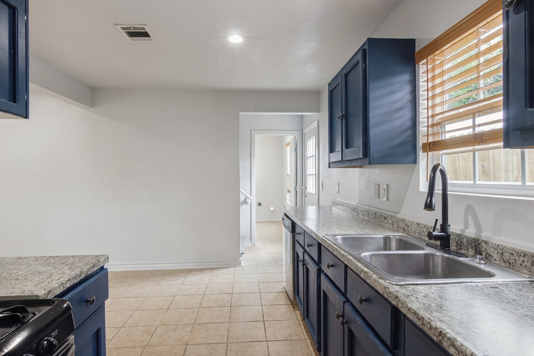 4505 Cochran Street Houston, TX 77009 - Photo 7 of 25 a kitchen with a sink stove and cabinets