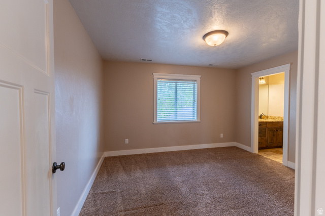 3565 West 1350th Street North Vernal, UT 84078 - Photo 27 of 54 Neutral tone painted walls with white trim, brown carpet flooring, and a single window with blinds