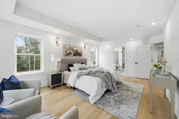 a bedroom with a large bed couch and a window