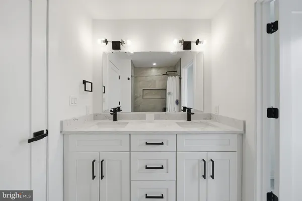 a bathroom with a double vanity sink and a mirror