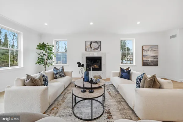 a living room with furniture fireplace and window
