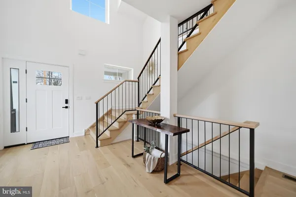 a view of staircase with white walls and a window