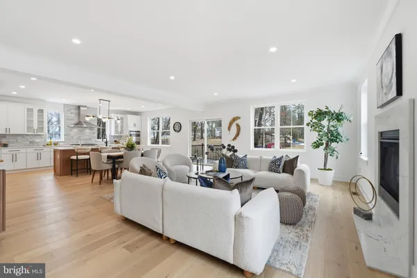 a living room with fireplace furniture and a large window