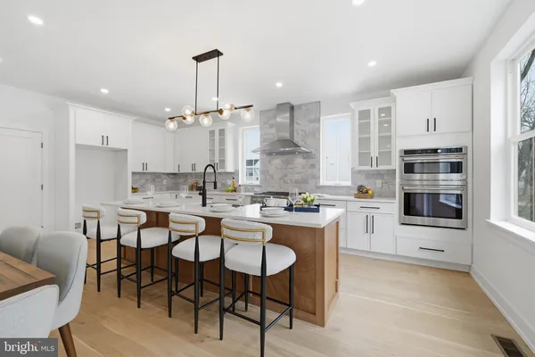 a kitchen with kitchen island granite countertop a table and chairs in it