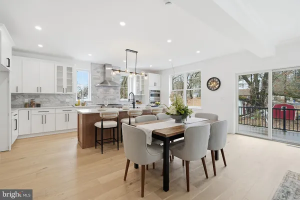 a view of kitchen with cabinets table and chairs