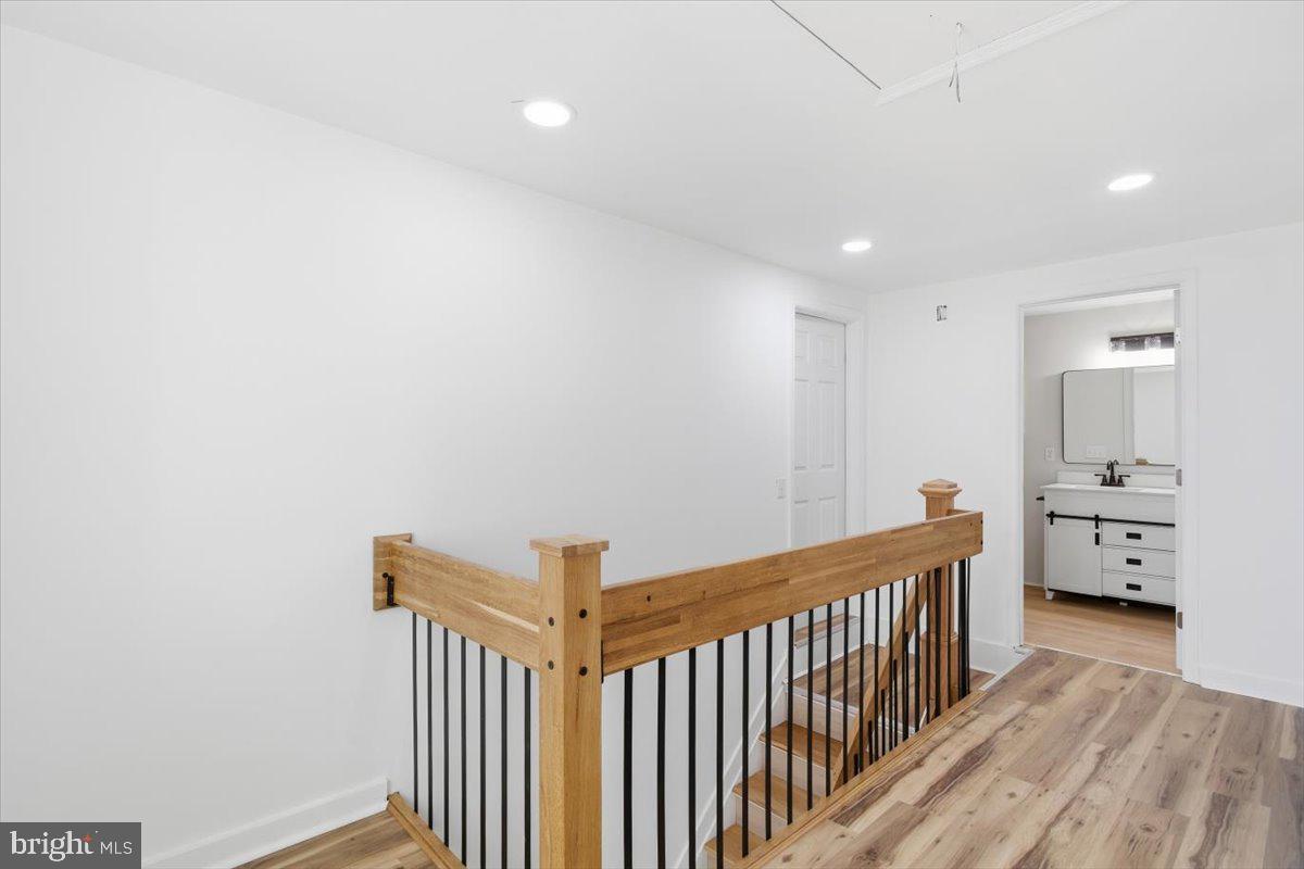 5026 Bethlehem Road Preston, MD 21655 - Photo 20 of 25 a view of a hallway with bathroom and wooden floor