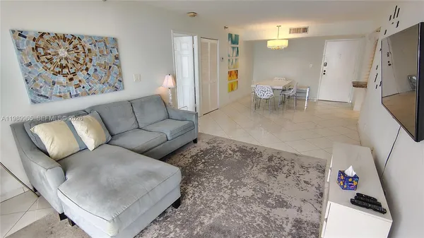 a living room with furniture and a dining table