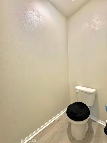 a white toilet sitting next to a white sink