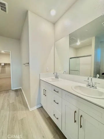 a bathroom with 2 sink and a mirror