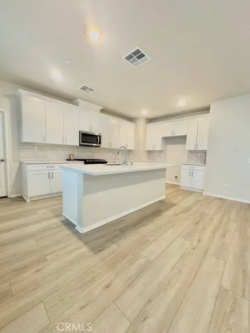a kitchen with stainless steel appliances cabinets a sink and a stove