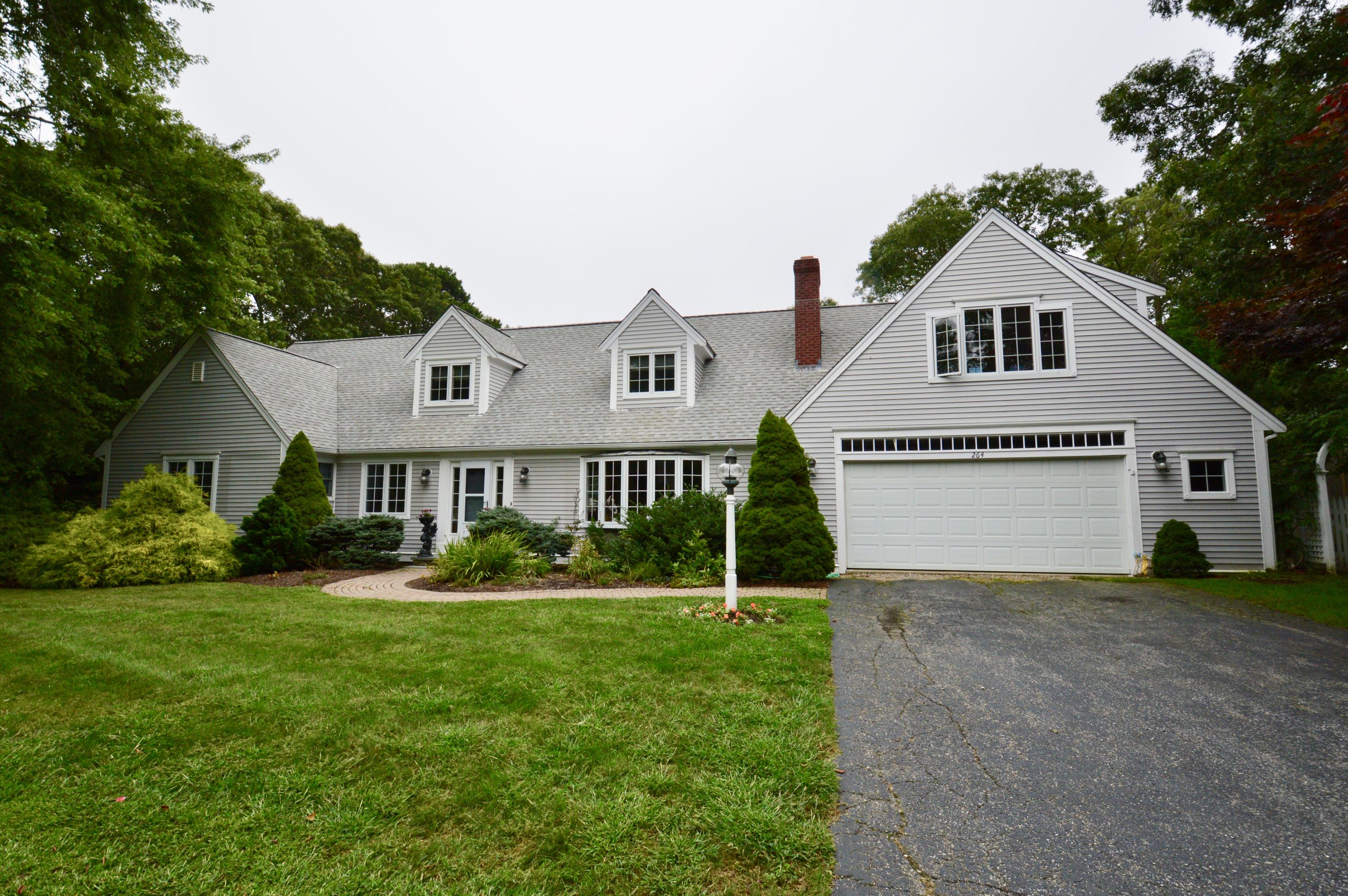 264 Cap'n Lijah's Road Centerville, MA 02632 - Photo 1 of 2 a front view of a house with a yard and garage