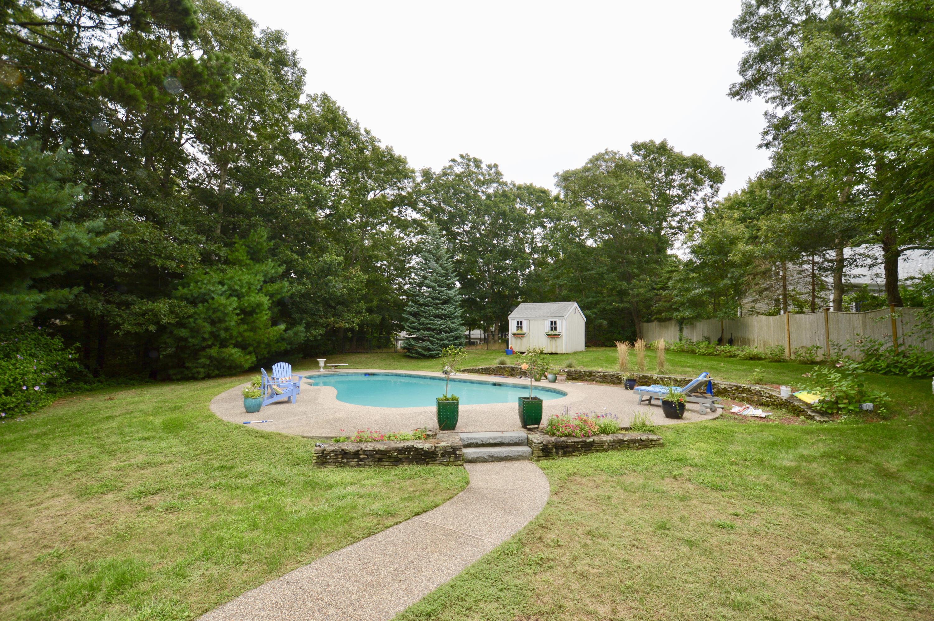 264 Cap'n Lijah's Road Centerville, MA 02632 - Photo 2 of 2 a front view of a house with sitting space and garden