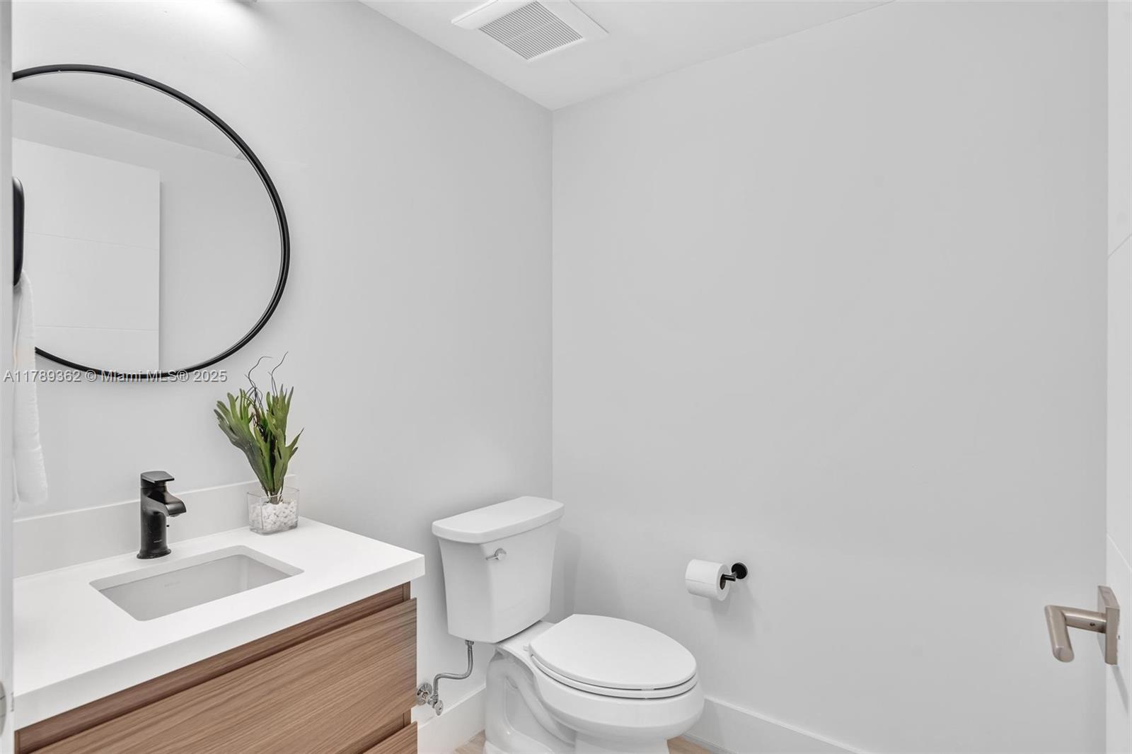1389 Southwest 22nd Terrace Miami, FL 33145 - Photo 25 of 63 a white toilet sitting next to a bathroom sink