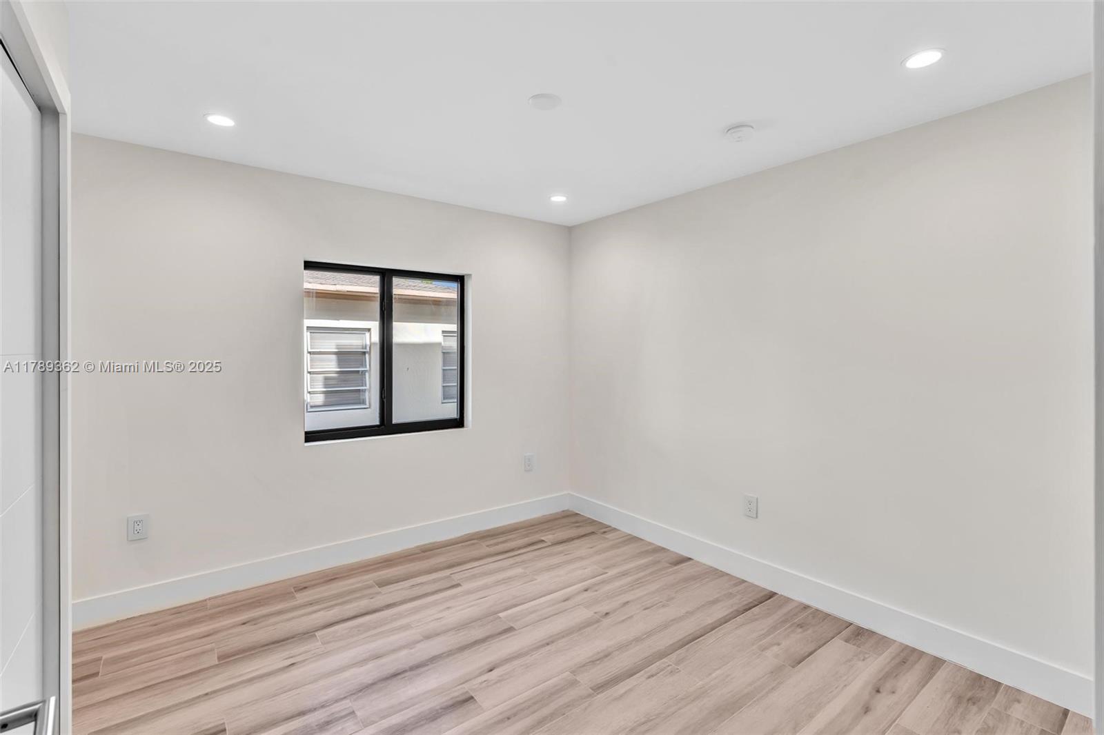 1389 Southwest 22nd Terrace Miami, FL 33145 - Photo 42 of 63 wooden floor in an empty room with a window