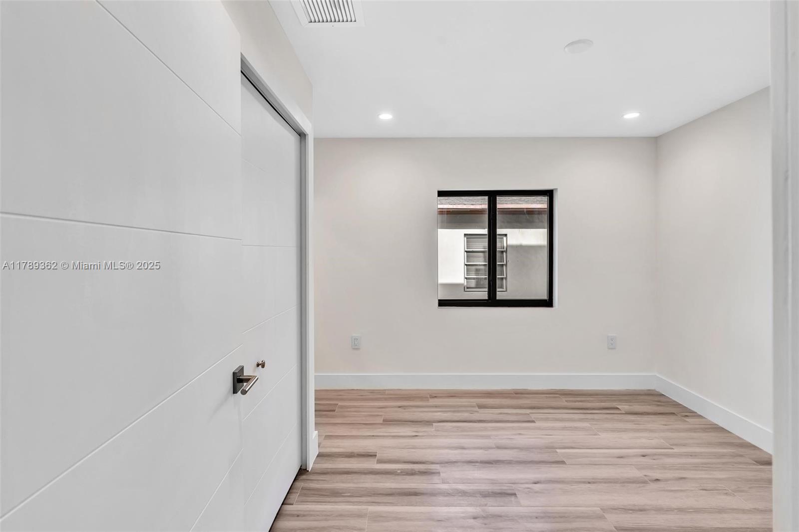 1389 Southwest 22nd Terrace Miami, FL 33145 - Photo 44 of 63 a view of empty room with wooden floor and fan