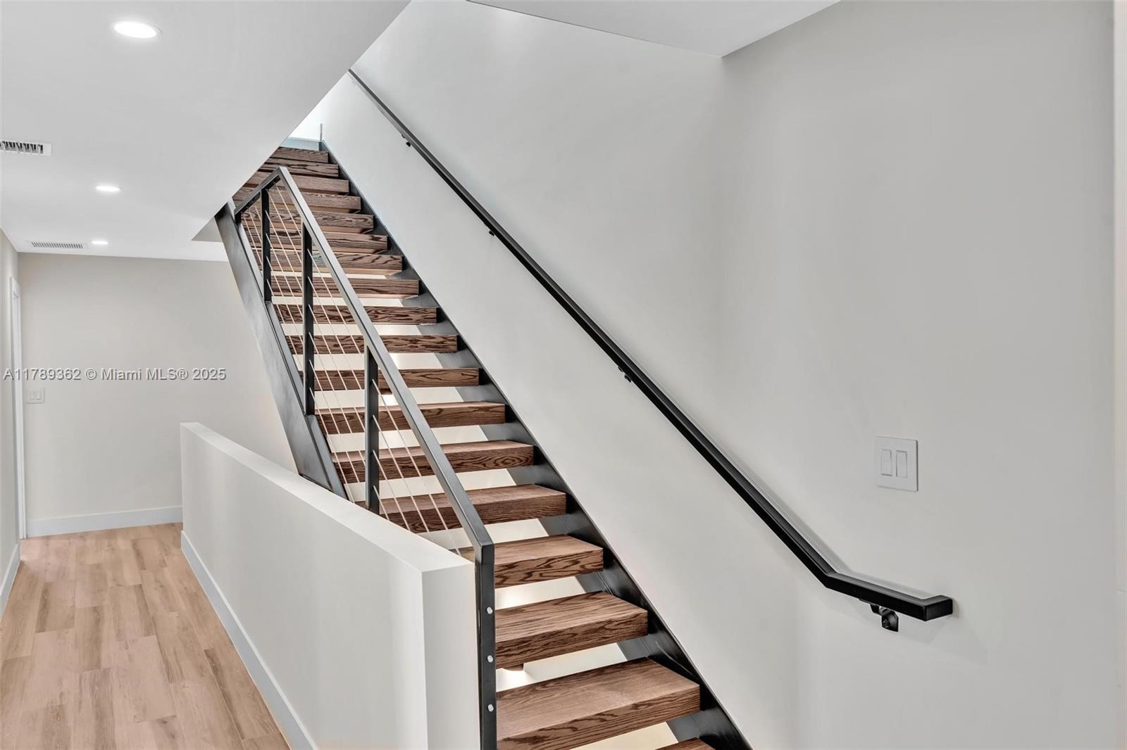 1389 Southwest 22nd Terrace Miami, FL 33145 - Photo 45 of 63 a view of staircase with wooden floor and white walls