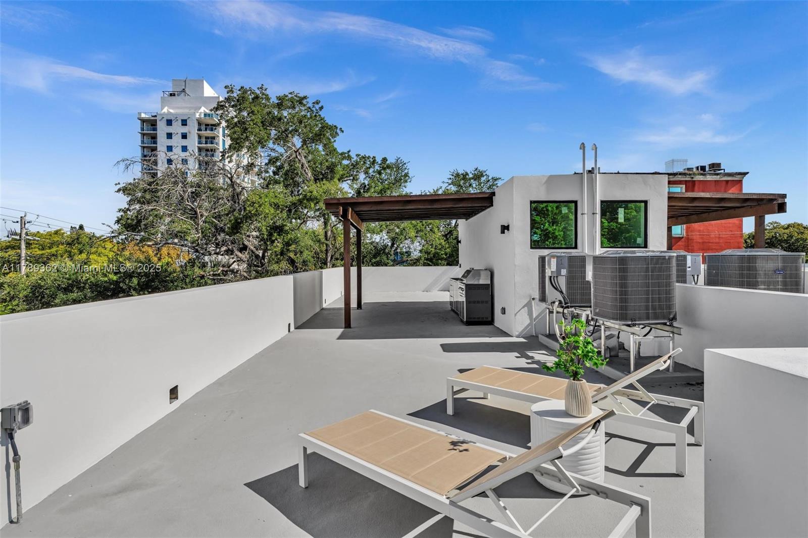 1389 Southwest 22nd Terrace Miami, FL 33145 - Photo 53 of 63 a view of a patio with couches and table and chairs with wooden fence
