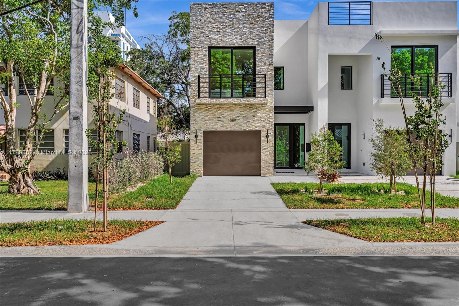 1389 Southwest 22nd Terrace Miami, FL 33145 - Photo 57 of 63 a front view of a house with a garden and plants