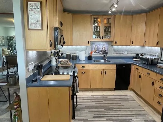 a kitchen with a sink stove and cabinets