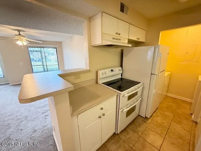 a kitchen with stainless steel appliances granite countertop a sink and a refrigerator