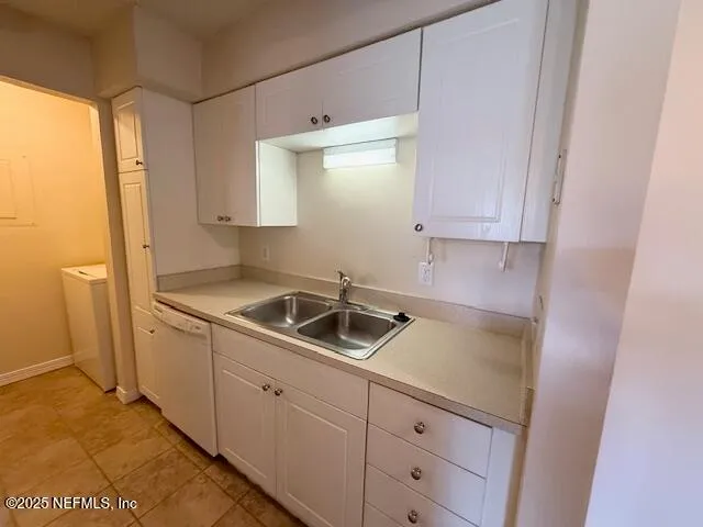 a kitchen with a sink and a stove top oven