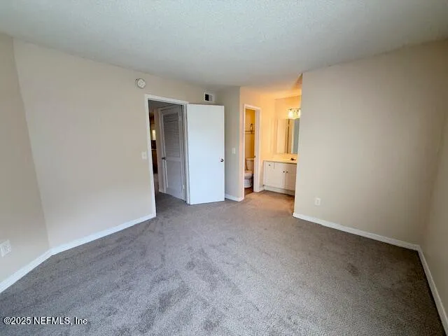 a spacious bathroom with a double vanity sink a mirror and a bathtub
