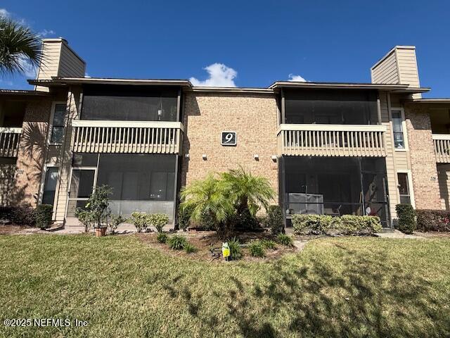 10200 Belle Rive Boulevard, Unit 69 Jacksonville, FL 32256 - Photo 3 of 27 a front view of a house with a yard