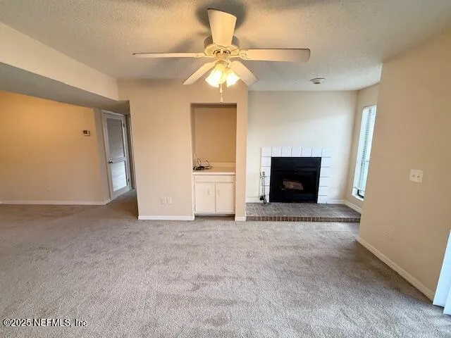 an empty room with a fireplace and wooden floor