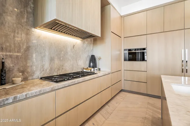 a kitchen with granite countertop a stove and a refrigerator