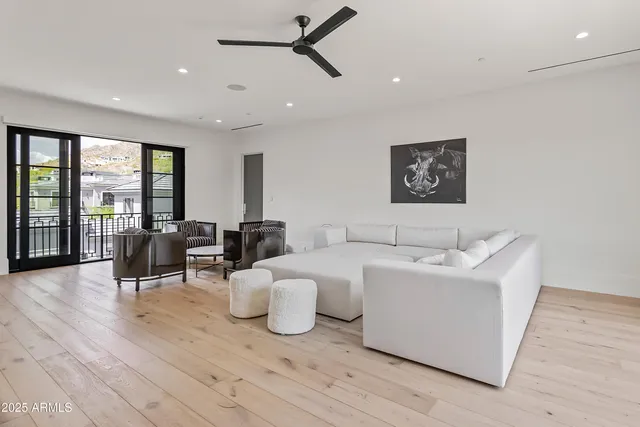 a living room with furniture and large windows