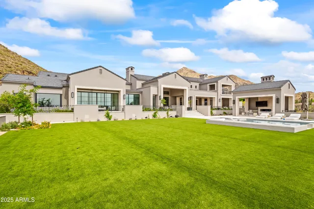 a front view of a house with a yard table and chairs