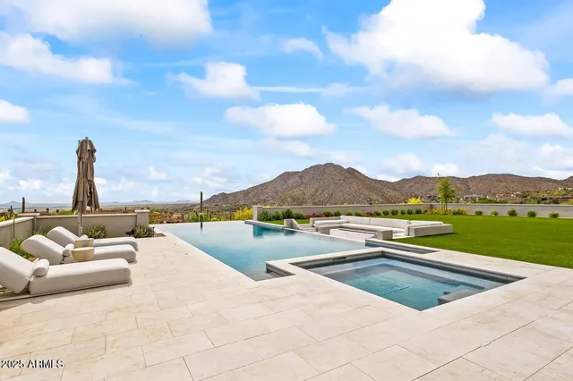 a view of swimming pool with a lounge chair