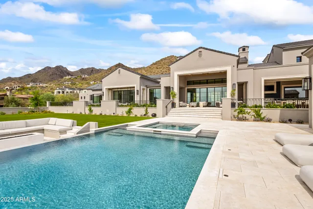 a view of house with yard and outdoor seating