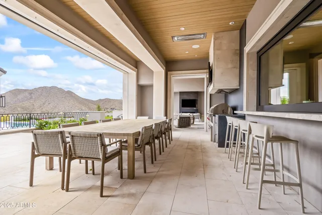 a living room with couches a flat screen tv and a large window