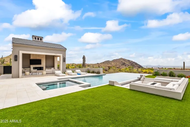a living room with furniture a fireplace and a large window