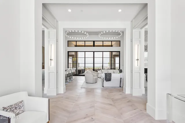 a living room with furniture and large windows