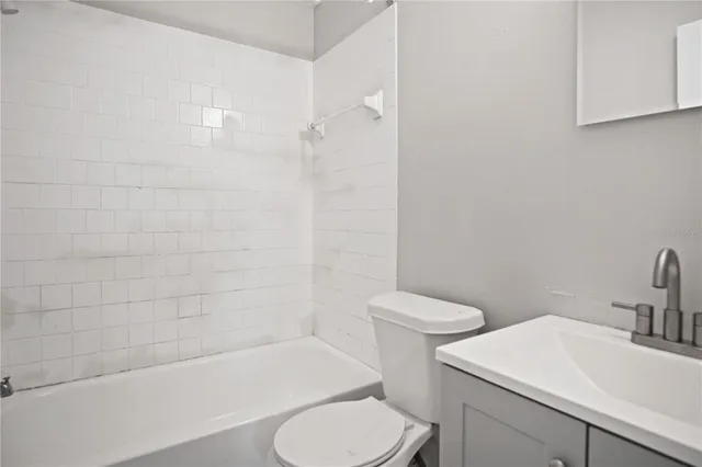 a bathroom with a toilet a sink and bathtub